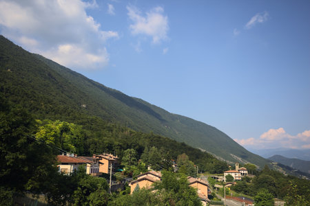 Mountain ridge with a forest and a village on it on a sunny day