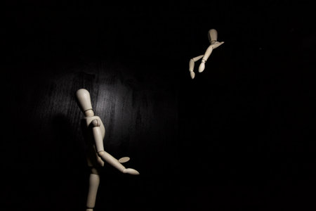 Mannequins pleading to one above them with open arms on a black backgroundの写真素材