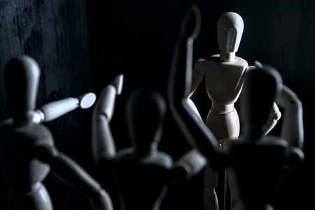 Mannequins pointing to another one posing still on a black backgroundの写真素材