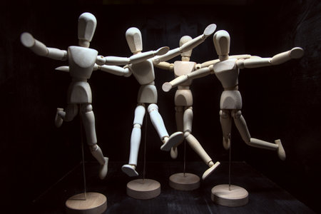 Models posing like they are in mid air on a black background seen up closeの写真素材