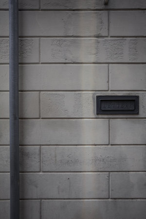 Opening of a letterbox in a stone wall seen up close