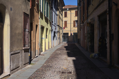 Cobbled alley of an Italian town with one side in the shade and the other one in full sunlightの写真素材