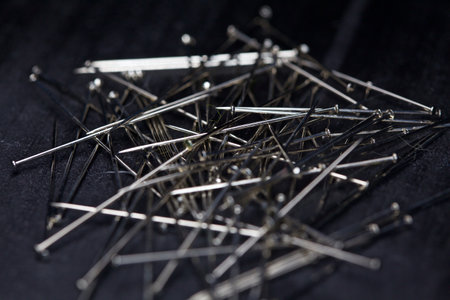 Needles on a black background seen up close