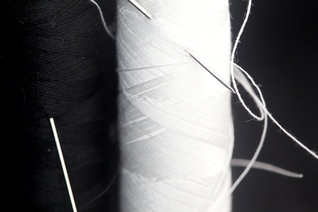Sewing thread on a black background seen up closeの写真素材