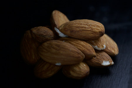 Almonds on a black background seen up close