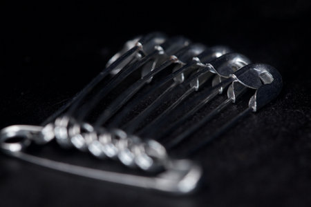 Safety pins on a black background seen up closeの写真素材