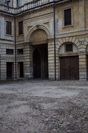 Corner in the shade of a square in the back of a palace with an arch as access to the squareの写真素材