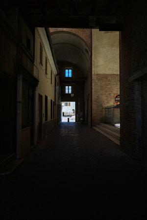 Covered alley passing through and under a palace in an Italian townの写真素材