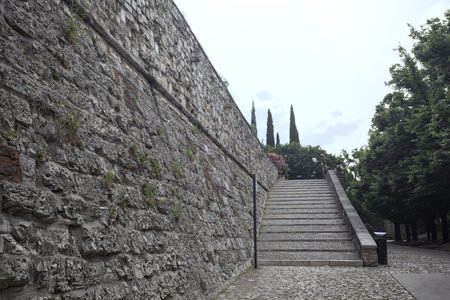 Staircase leaning on the inner wall of a castle on a sunny day