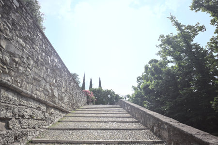 Staircase leaning on the inner wall of a castle on a sunny dayの写真素材