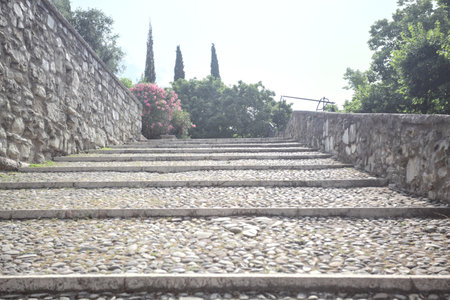 Staircase leaning on the inner wall of a castle on a sunny dayの写真素材