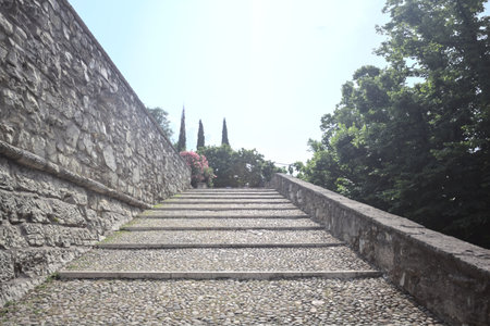 Staircase leaning on the inner wall of a castle on a sunny dayの写真素材
