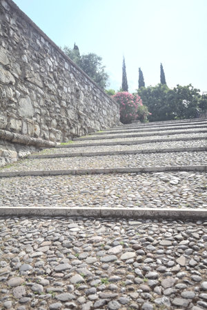 Staircase leaning on the inner wall of a castle on a sunny dayの写真素材