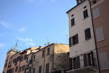 Facades with balconies of buildings in an Italian town at sunsetの写真素材