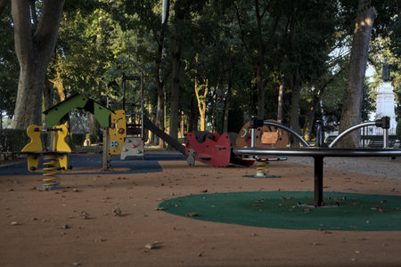 Empty playground in a public park at sunset