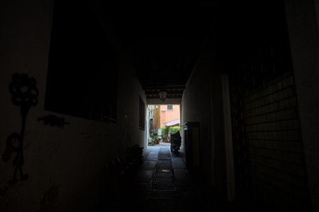 Covered corridor in a building that leads to an inner yard in an Italian townの写真素材