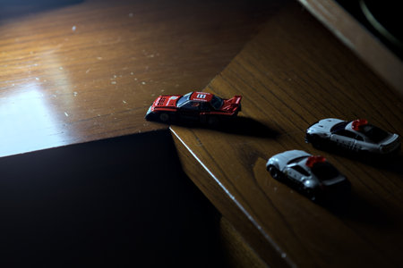 Genoa, Italy - 20TH NOVEMBER 2025 - Takara Tomi replicas of a Nissan Skyline Turbo Super Silhouette in red and black race livery pretending to be chased by replicas of a Nissan Skyline GT-R R34 in japanese police livery and a Nissan Fairlady 350Z also in のeditorial素材