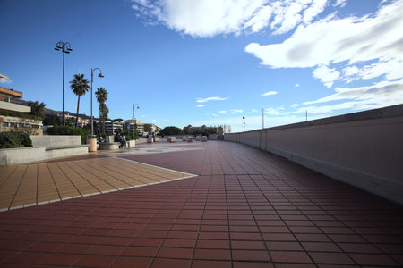 Genoa, Italy - 26TH NOVEMBER 2025 - Corso Italia boulevard by the sea with people passing by on a sunny day with scattered cloudsのeditorial素材