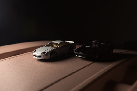 Mantua, Italy - 9TH DECEMBER 2025 - Replicas of a white Mitsubishi 3000GT and a black Toyota MR2 on...
