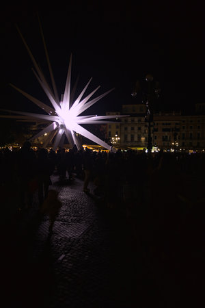 Verona, Italy - 8TH DECEMBER 2025 - Lit Christmas market stalls next to the Arena di Verona and the...