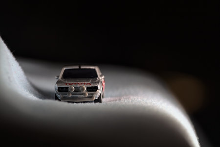 Mantua, Italy - 14TH DECEMBER 2025 - Majorette replica of a Toyota Celica GT Coupein silver and red livery pretending to run on a snowy road by the edge of a cliffのeditorial素材