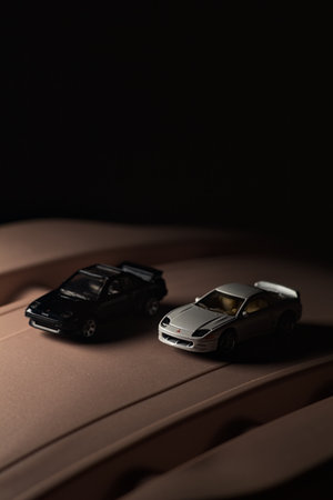 Mantua, Italy - 9TH DECEMBER 2025 - Replicas of a white Mitsubishi 3000GT and a black Toyota MR2 on...