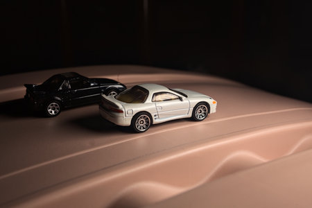 Mantua, Italy - 9TH DECEMBER 2025 - Replicas of a white Mitsubishi 3000GT and a black Toyota MR2 on...
