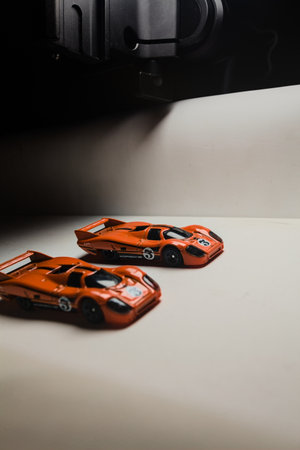 Mantua, Italy - 28TH DECEMBER 2025 - Hot Wheels replicas of two Porsche 917C in orange race livery...