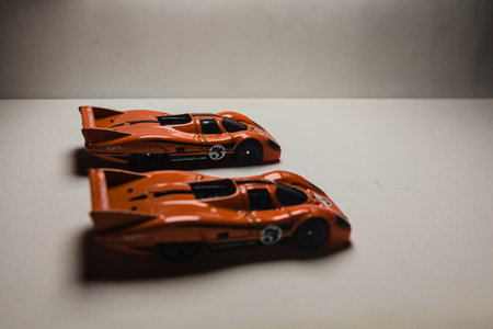 Mantua, Italy - 28TH DECEMBER 2025 - Hot Wheels replicas of two Porsche 917C in orange race livery...