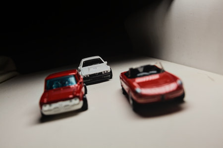 Mantua, Italy - 28TH DECEMBER 2025 - Hot Wheels replicas of an Alfa Romeo Giulietta Spider, an Alfa Romeo Giulia Sprint and an Alfa Romeo Alfetta GT in race livery pretending to have a race on a race trackのeditorial素材