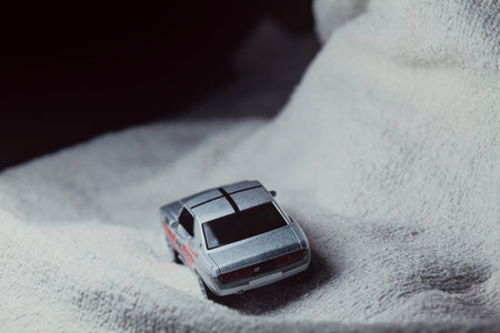 Mantua, Italy - 10TH JANUARY 2025 - Majorette replica of a Toyota Celica GT Coupe pretending to run a rally on a snowy road, next to a cliff, in the mountainsのeditorial素材