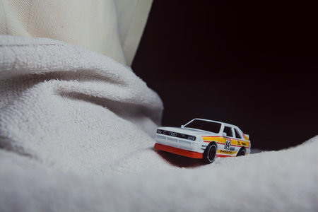 Mantua, Italy - 10TH JANUARY 2025 - Hot Wheels replica of a 1984 Audi Sport Quattro in rally livery and trim pretending to run a rally on a snowy road, next to a cliff, in the mountainsのeditorial素材