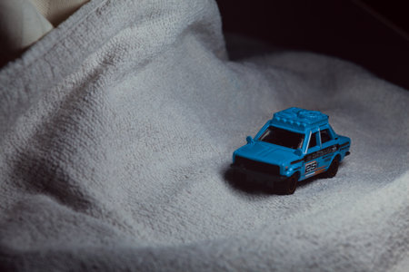 Mantua, Italy - 10TH JANUARY 2025 - Matchbox replica of a 1970 Datsun 510 in rally livery and trim pretending to run a rally on a snowy road, next to a cliff, in the mountainsのeditorial素材
