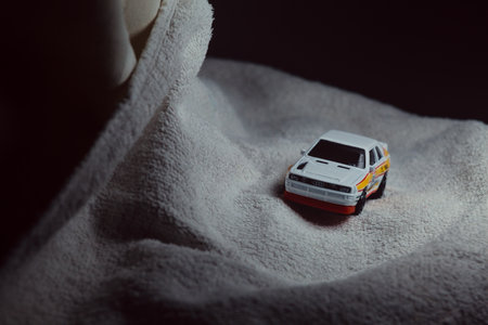 Mantua, Italy - 10TH JANUARY 2025 - Hot Wheels replica of a 1984 Audi Sport Quattro in rally livery and trim pretending to run a rally on a snowy road, next to a cliff, in the mountainsのeditorial素材