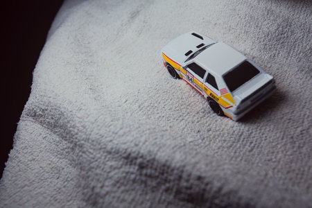 Mantua, Italy - 10TH JANUARY 2025 - Hot Wheels replica of a 1984 Audi Sport Quattro in rally livery and trim pretending to run a rally on a snowy road, next to a cliff, in the mountainsのeditorial素材