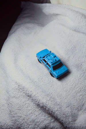 Mantua, Italy - 10TH JANUARY 2025 - Matchbox replica of a 1970 Datsun 510 in rally livery and trim pretending to run a rally on a snowy road, next to a cliff, in the mountainsのeditorial素材