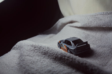 Mantua, Italy - 10TH JANUARY 2025 - Hot Wheels replica of an Audi 90 Quattro pretending to run a rally on a snowy road, next to a cliff, in the mountainsのeditorial素材