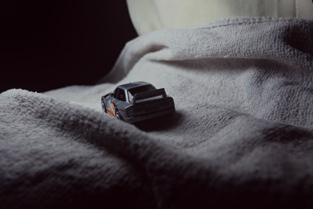 Mantua, Italy - 10TH JANUARY 2025 - Hot Wheels replica of an Audi 90 Quattro pretending to run a rally on a snowy road, next to a cliff, in the mountainsのeditorial素材