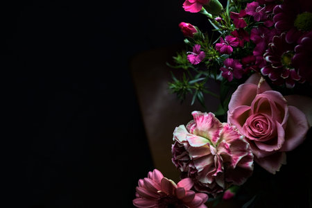 Pink toned bouquet with a pink rose, a pink gerbera and carnations in purple and pink, seen up...