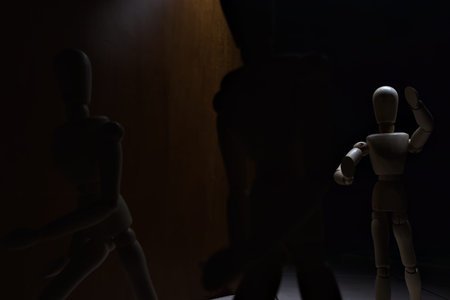 Wooden mannequin in the act of raising its arms and running towards other three mannequins in the act of escaping from itの写真素材