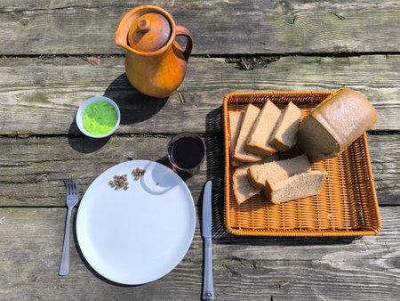 The freshest, warm bread lying next to a white plate on an antique table.の写真素材