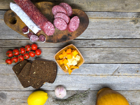 Wooden cutting board with sliced salami. High quality photoの写真素材