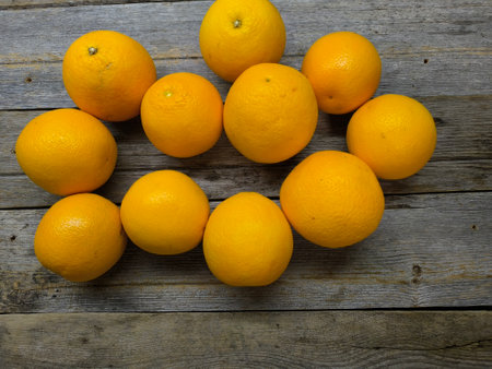 juicy oranges on a wooden table.