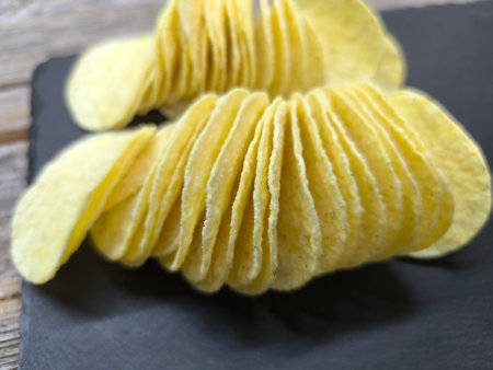 crispy potato chips on a sliced boardの写真素材