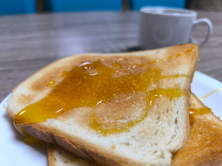 Fried white bread doused with honey on a white plate.