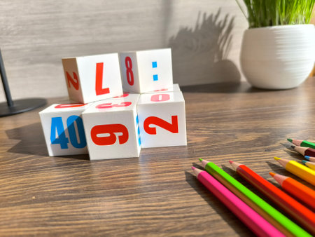 Cubes with numbers and pencils on a wooden table. High-quality photos