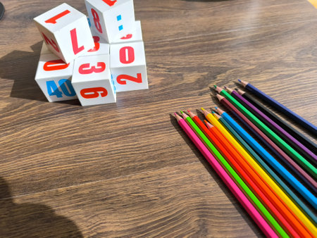 Cubes with numbers and pencils on a wooden table. High-quality photos