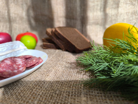 Sliced cured sausage on a white plate. High quality photosの写真素材