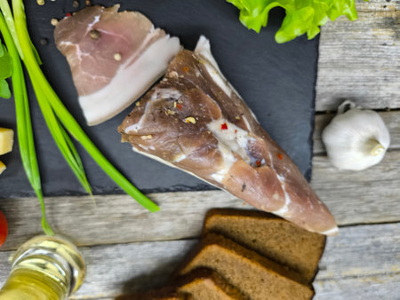 delicious piece of dried meat on a sliced boardの写真素材