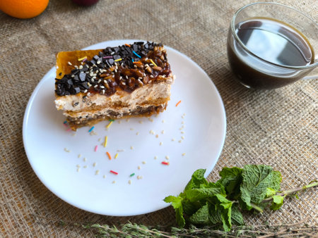 piece of delicious cake and a cup of tea with green mint. High quality photos
